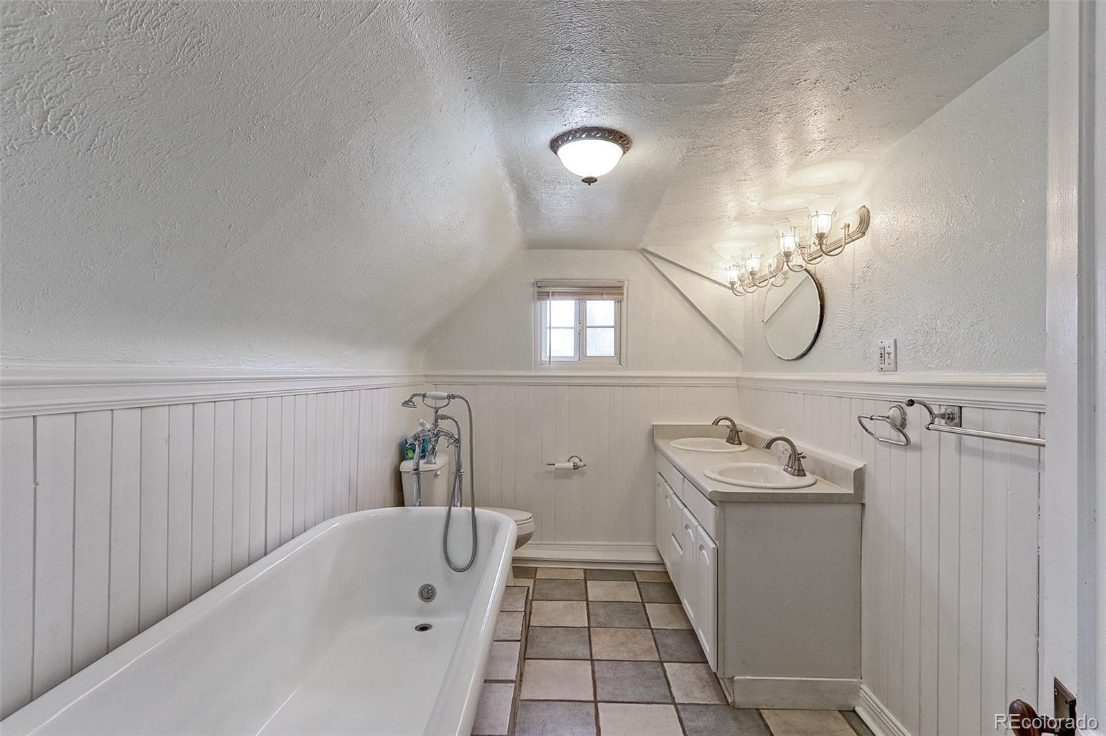 4576 Stuart Street Denver, CO 80212 - Photo 20 of 43 a bathroom with a sink a toilet and shower