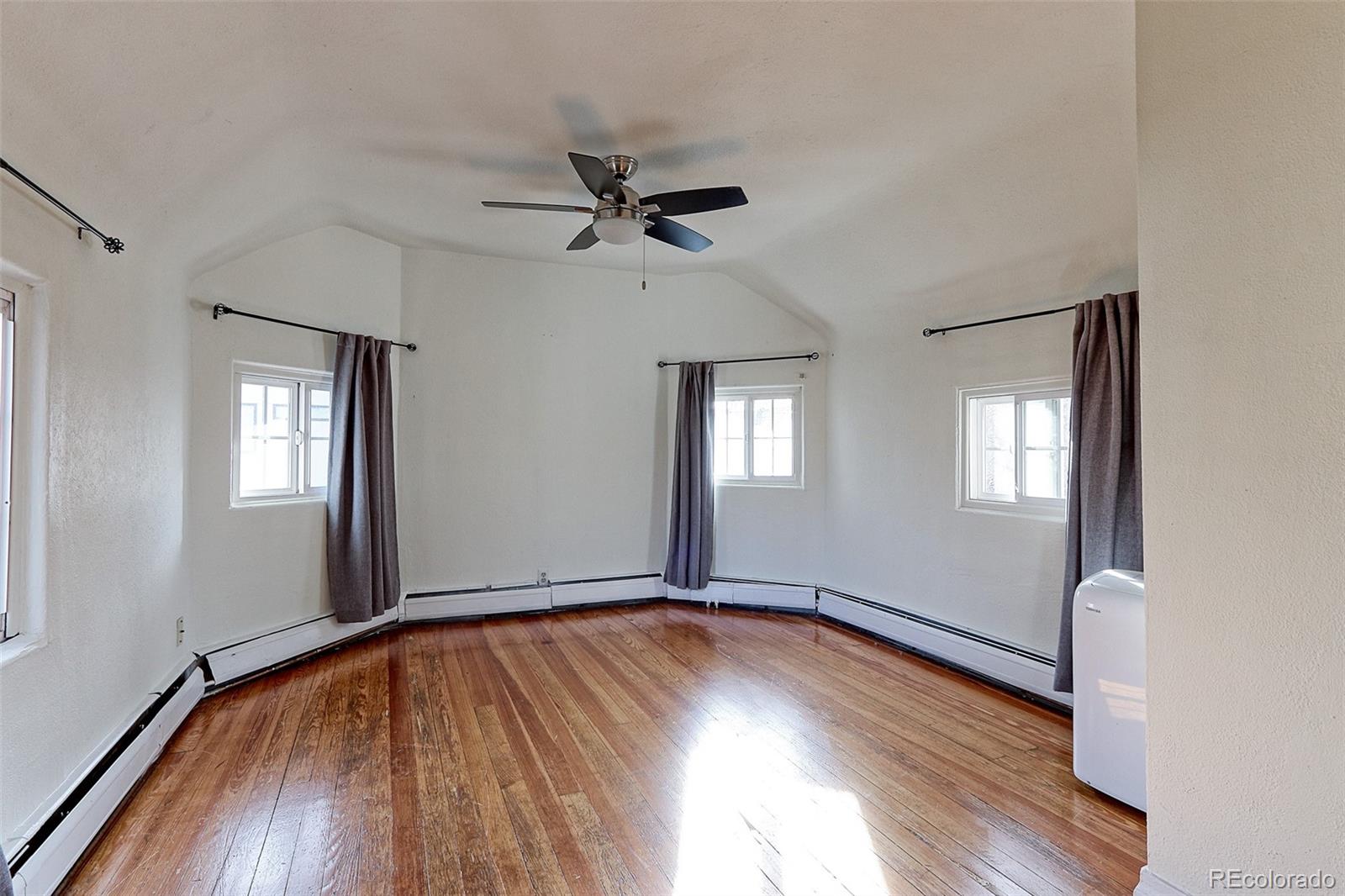 4576 Stuart Street Denver, CO 80212 - Photo 37 of 43 a view of empty room with wooden floor and fan