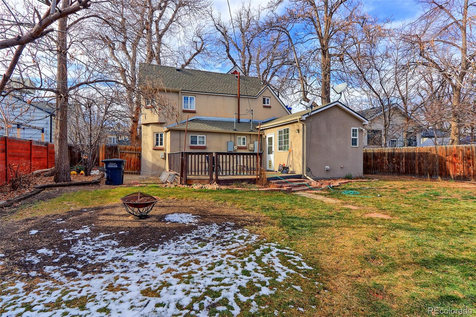 4576 Stuart Street Denver, CO 80212 - Photo 41 of 43 a view of a house with a yard covered in the forest