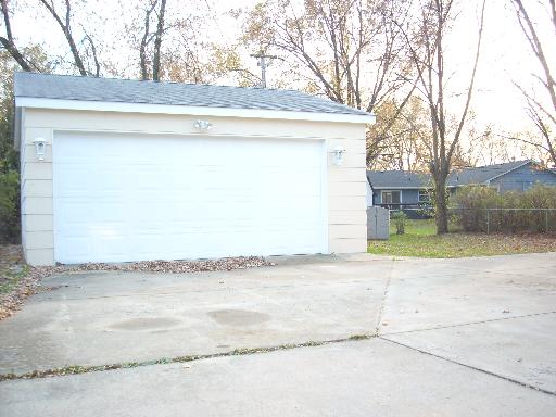 307 East Harrison Road Lombard, IL 60148 - Photo 16 of 16 a view of a house with a yard and a garage