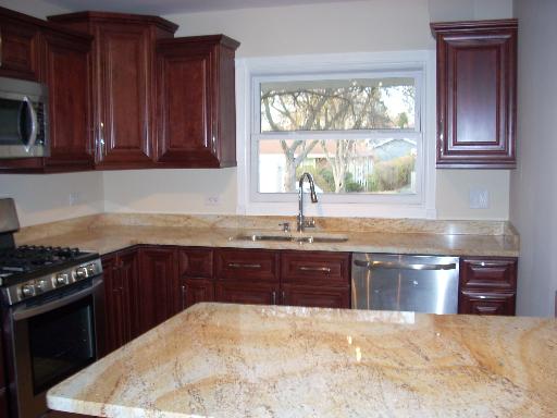 307 East Harrison Road Lombard, IL 60148 - Photo 3 of 16 a kitchen with stainless steel appliances granite countertop a stove a sink and a microwave