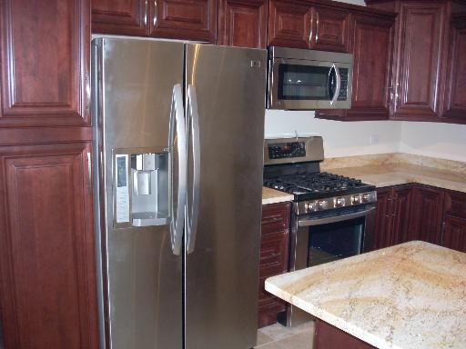 307 East Harrison Road Lombard, IL 60148 - Photo 4 of 16 a kitchen with stainless steel appliances granite countertop a refrigerator stove top oven and sink