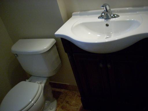 307 East Harrison Road Lombard, IL 60148 - Photo 6 of 16 a bathroom with a toilet sink and mirror