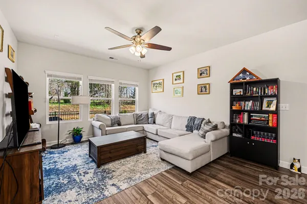 a living room with furniture a rug and a flat screen tv