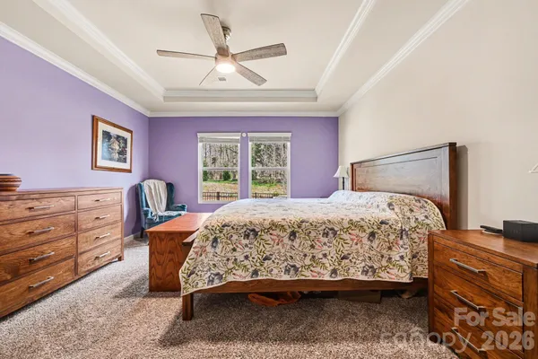 a bedroom with a bed dresser and a window