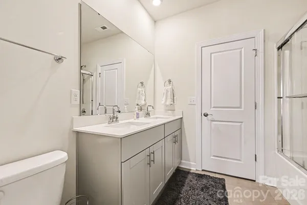 a spacious bathroom with a sink toilet and shower