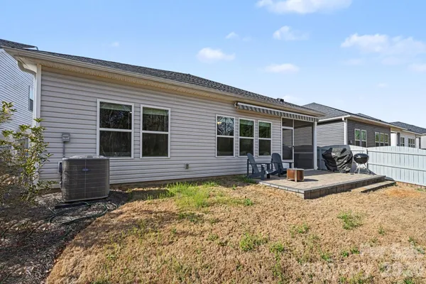 a view of a house with swimming pool and sitting area