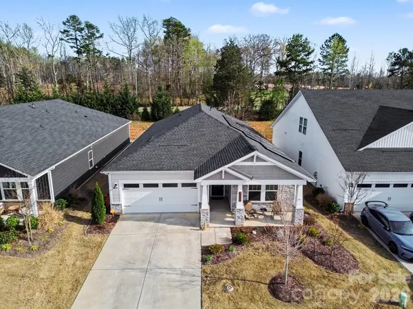 a aerial view of a house with a yard