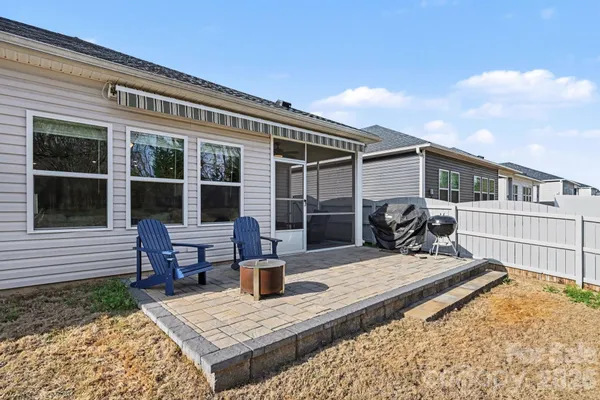a view of a house with backyard patio and swimming pool