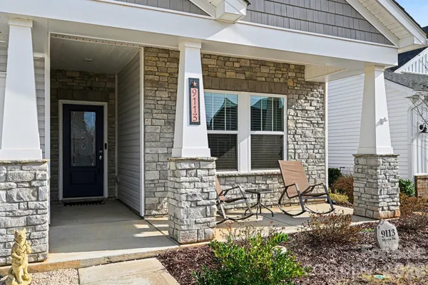 a front view of a house with outdoor seating