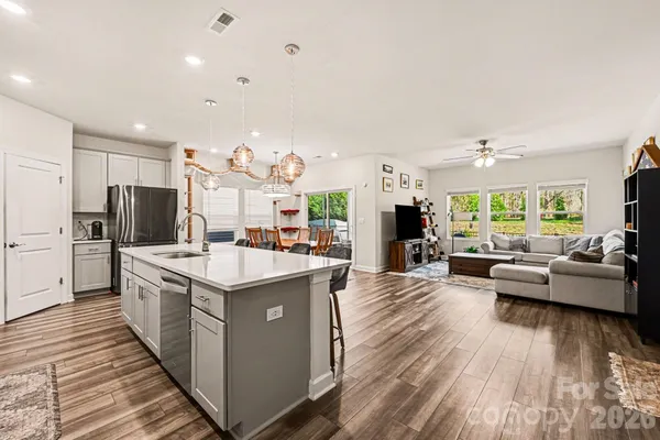 a kitchen with counter top space a sink appliances and cabinets