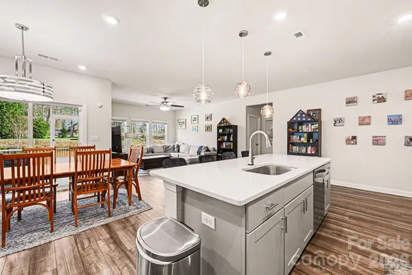 a large kitchen with a table and chairs
