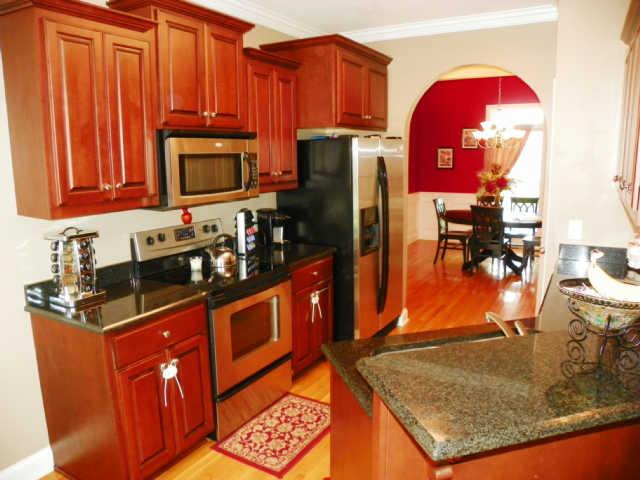 708 Heritage Road Lebanon, TN 37087 - Photo 7 of 15 a kitchen with stainless steel appliances granite countertop a refrigerator a stove and a sink