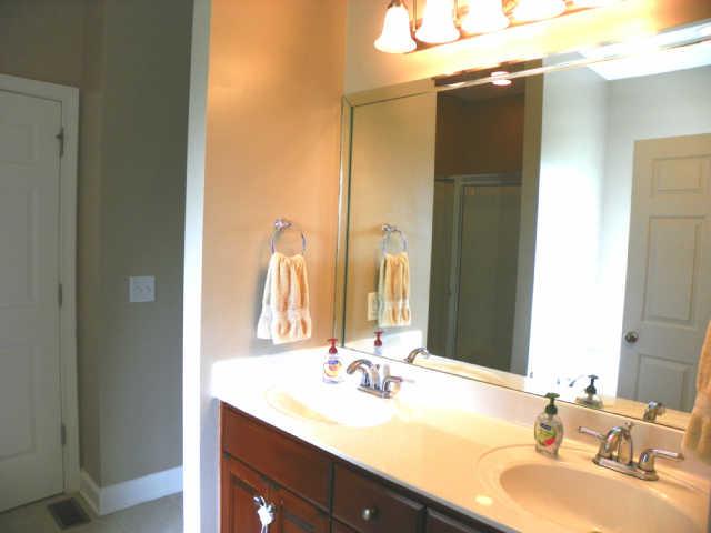 708 Heritage Road Lebanon, TN 37087 - Photo 9 of 15 a bathroom with a double vanity sink and a mirror