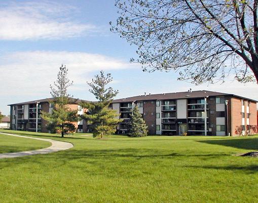 1327 Modaff Road, Unit C3 Naperville, IL 60565 - Photo 1 of 1 a view of a building with a big yard and large trees