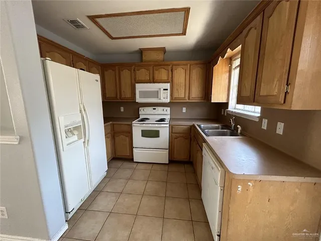 a kitchen with a stove a sink and a refrigerator