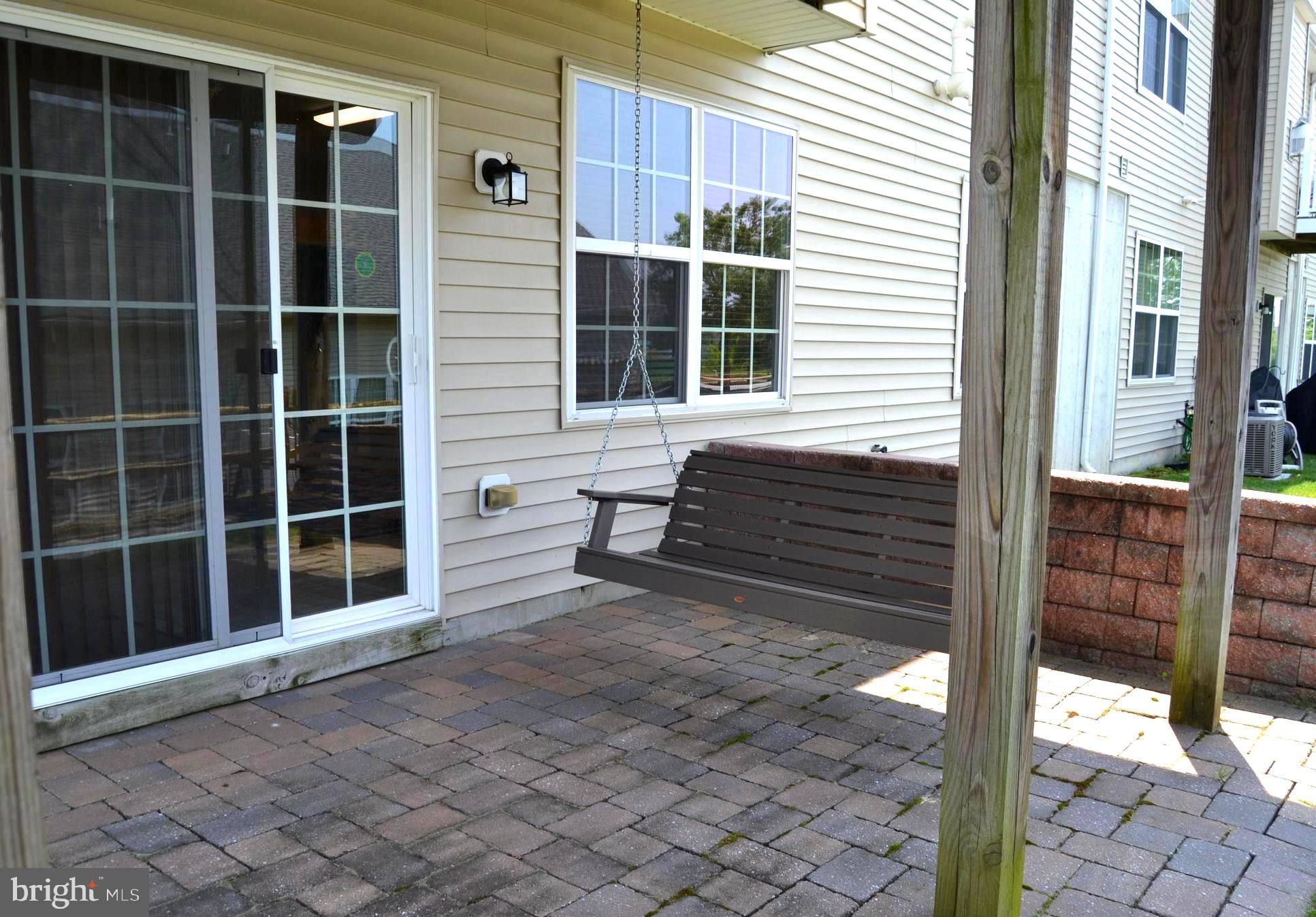 152 Stoyer Road Coatesville, PA 19320 - Photo 26 of 68 Brick paver patio with stone wall behind swing
