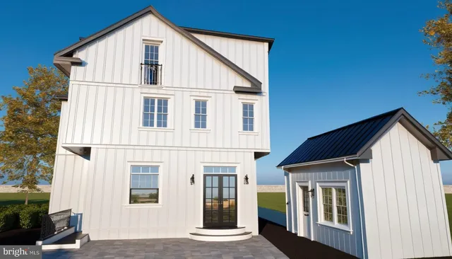 a view of a white house with large windows