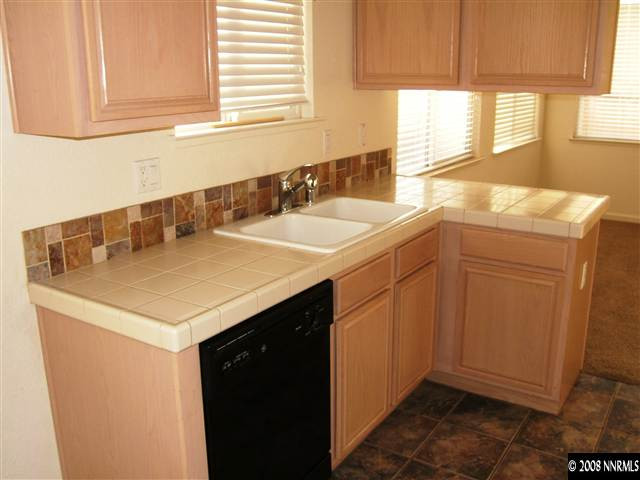 10035 Hampton Park Drive Reno, NV 89521 - Photo 3 of 9 a kitchen with a sink cabinets and a window