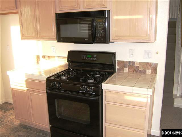 10035 Hampton Park Drive Reno, NV 89521 - Photo 4 of 9 a stove top oven sitting inside of a kitchen