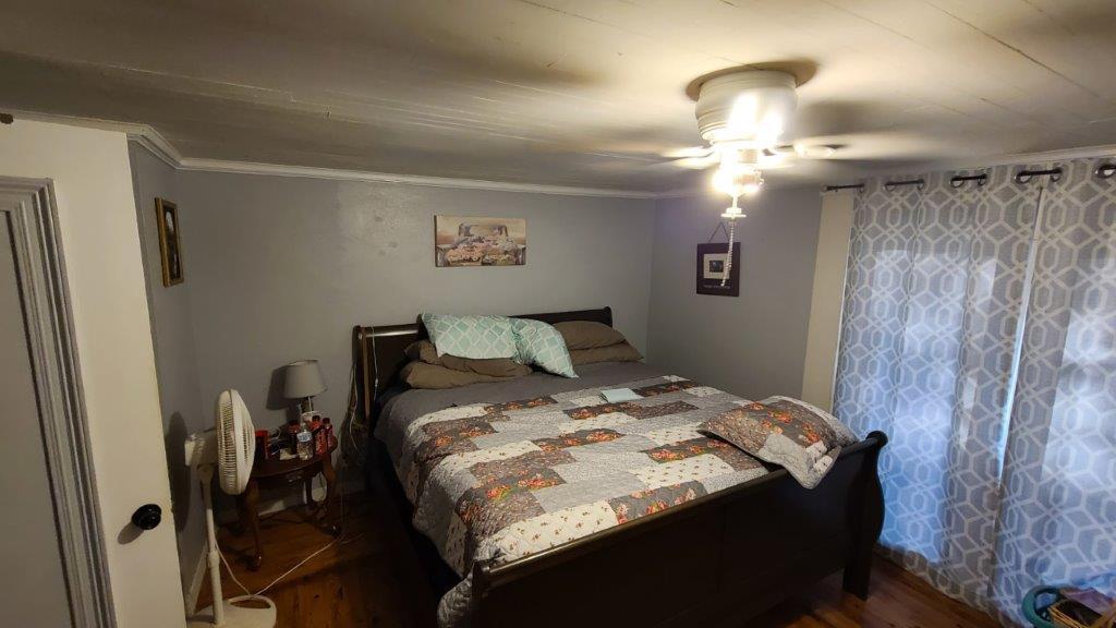 1155 Shady Grove Church Road Baker, FL 32531 - Photo 29 of 113 a bedroom with a bed and a chandelier