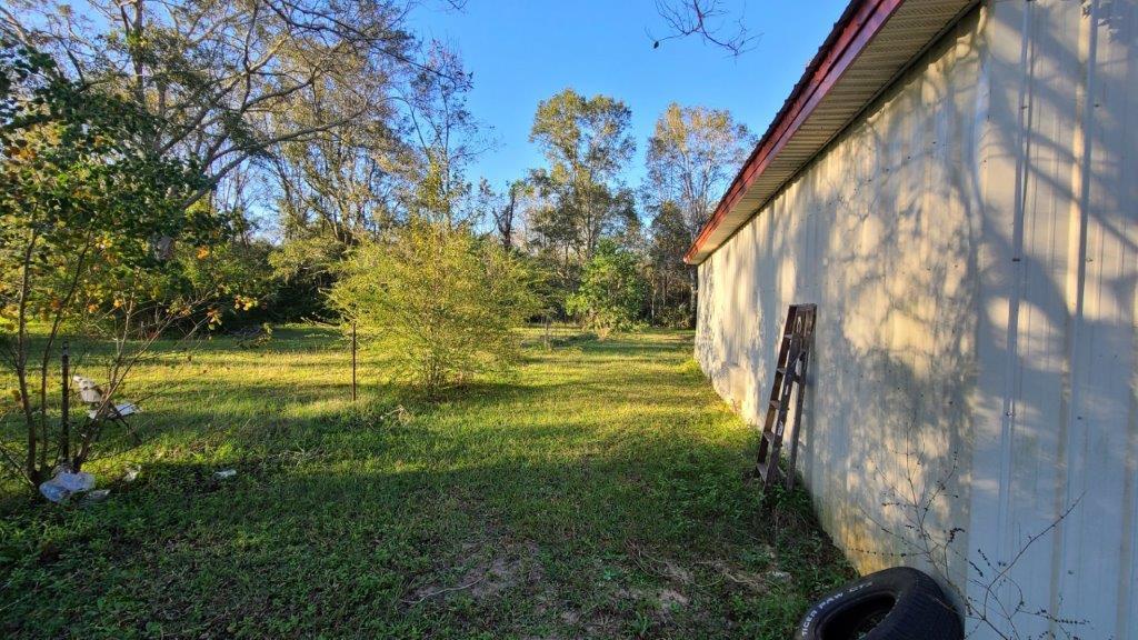 1155 Shady Grove Church Road Baker, FL 32531 - Photo 84 of 113 a view of a big yard with potted plants and large tree