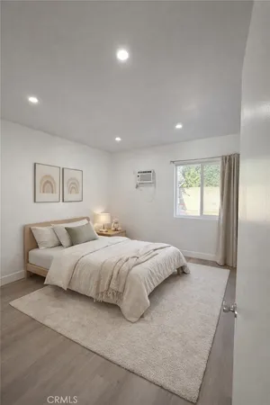 a bedroom with a large bed and a window