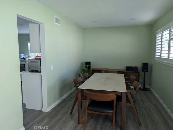 a view of a workspace with furniture and wooden floor