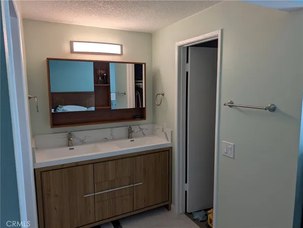 a bathroom with a double vanity sink and mirror