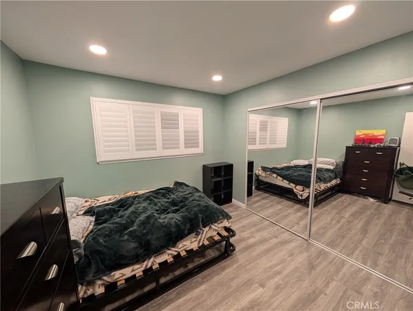 a bedroom with bed and window