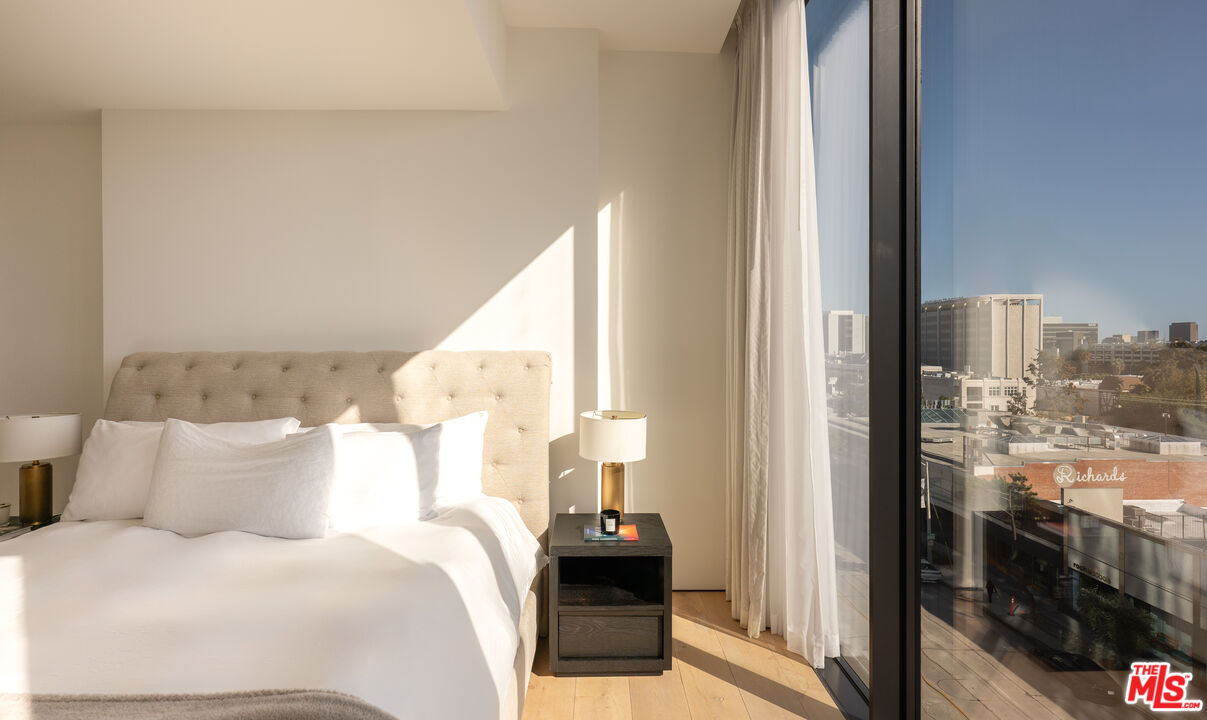 8899 Beverly Boulevard, Unit 6G Los Angeles, CA 90048 - Photo 13 of 25 a bedroom with a bed and a view of balcony