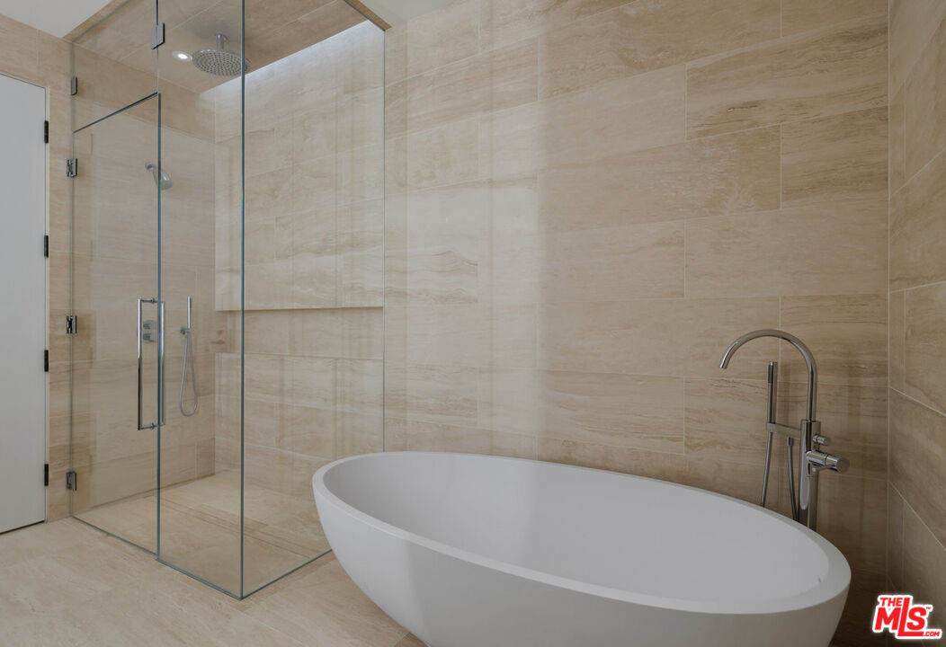 8899 Beverly Boulevard, Unit 6G Los Angeles, CA 90048 - Photo 16 of 25 a white bath tub sitting next to a shower