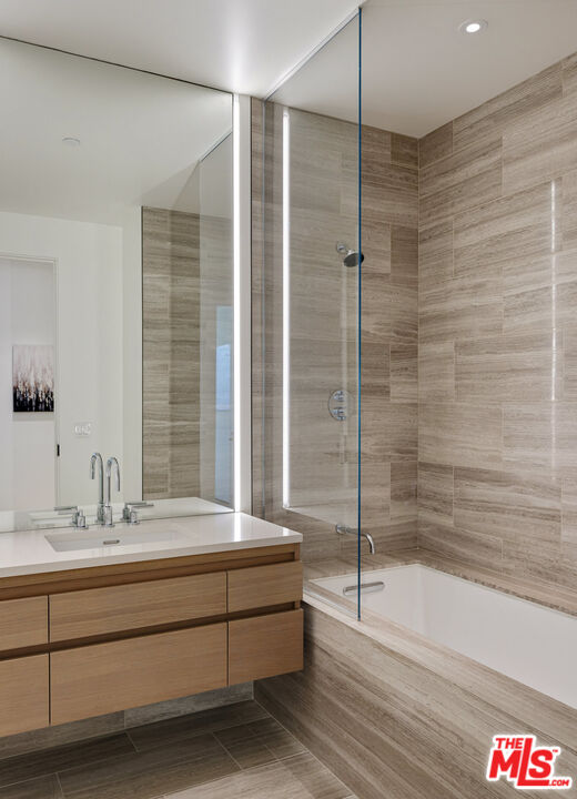 8899 Beverly Boulevard, Unit 6G Los Angeles, CA 90048 - Photo 18 of 25 a bathroom with a granite countertop sink mirror and bathtub