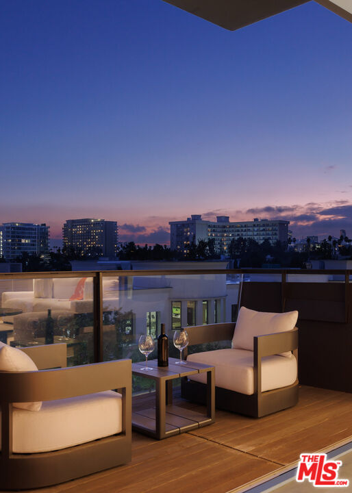8899 Beverly Boulevard, Unit 6G Los Angeles, CA 90048 - Photo 20 of 25 a view of roof deck with couches and city view