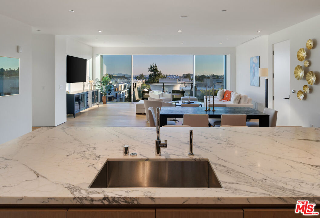 8899 Beverly Boulevard, Unit 6G Los Angeles, CA 90048 - Photo 10 of 25 a living room with kitchen island furniture and a kitchen view