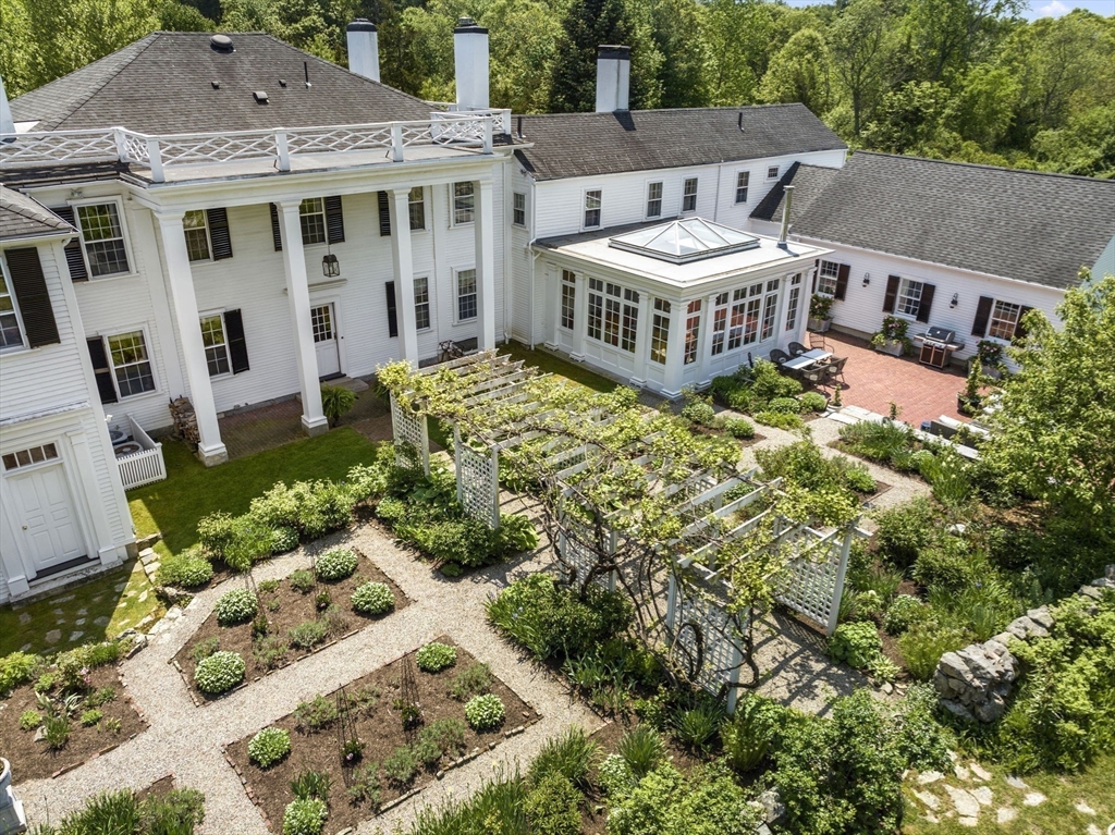 427 Concord Road Sudbury, MA 01776 - Photo 38 of 42 a front view of a house with a yard garden and outdoor seating