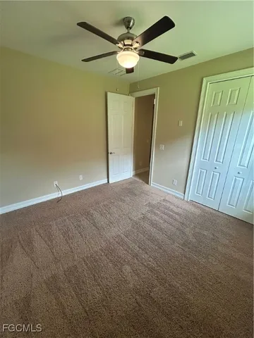 en empty room with fan and window