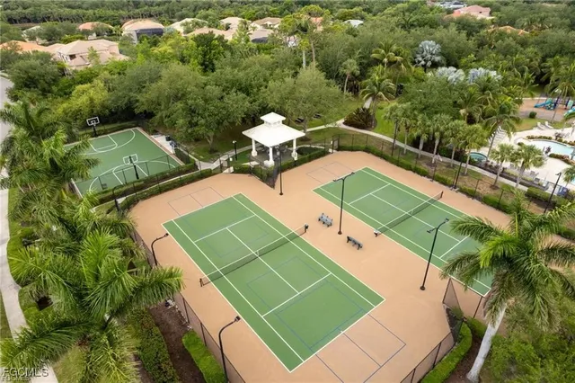 an aerial view of a tennis ground and a houses
