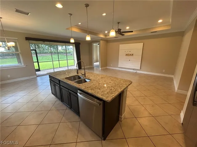 a kitchen with granite countertop a sink and a stove