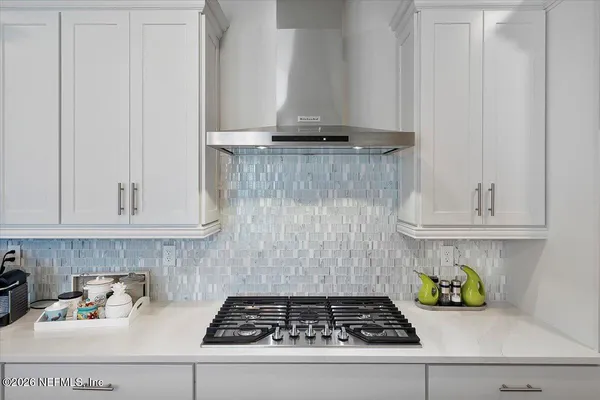 a kitchen with a stove and cabinets