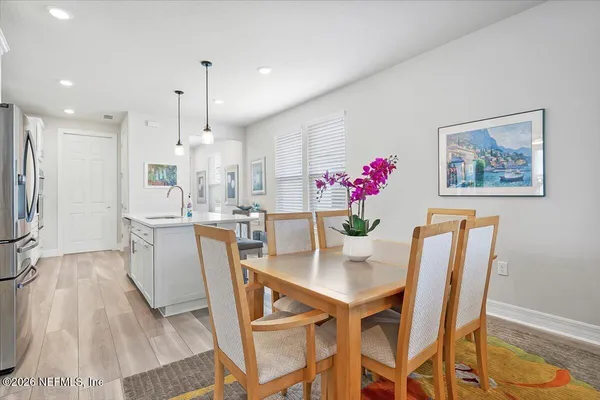 a dining room with furniture and wooden floor