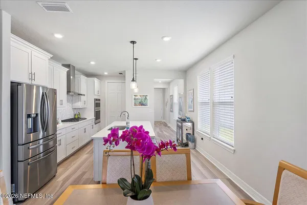 a kitchen with a refrigerator and a stove