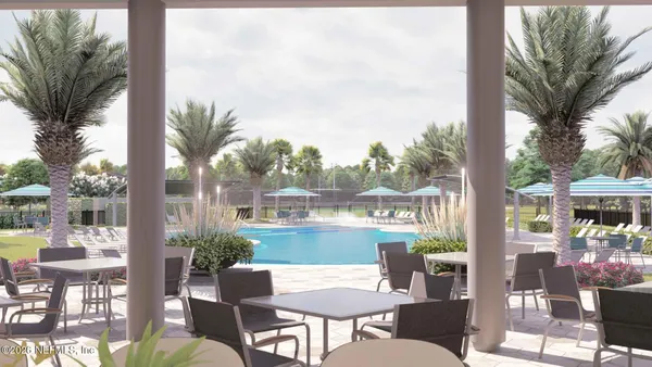a patio with water view and outdoor seating