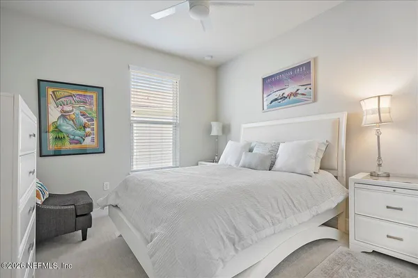 a bedroom with a bed and a painting on the wall