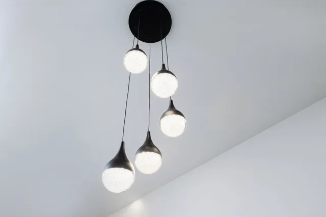 a kitchen with granite countertop a refrigerator and a stove top oven