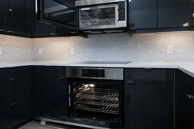 a bathroom with a double vanity sink a toilet and shower