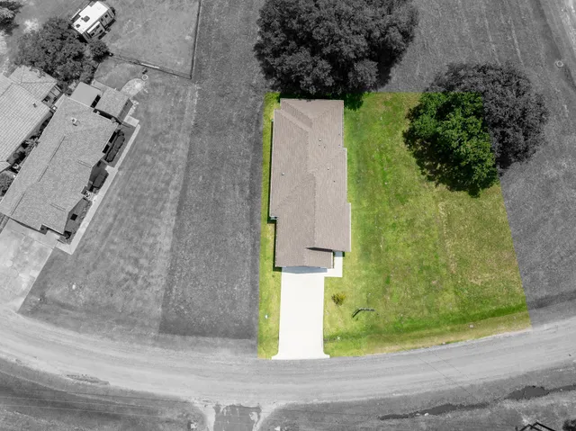 an aerial view of a golf course with chairs