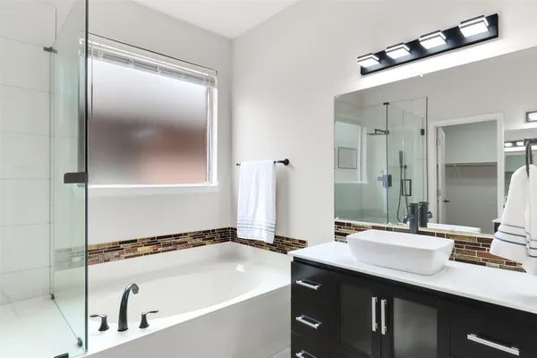 a bathroom with a bathtub and a sink