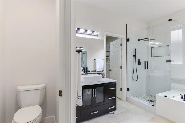 a bathroom with a granite countertop sink toilet and shower