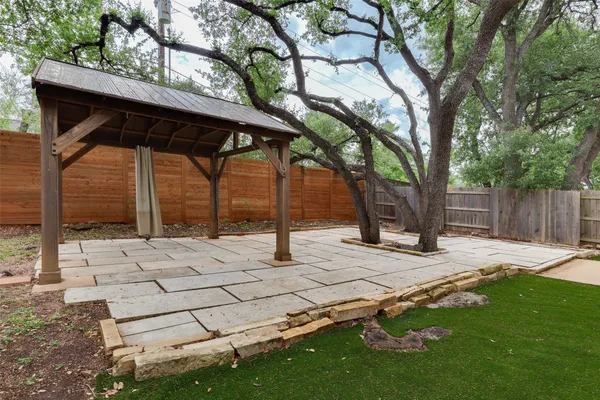 a wooden bench sitting in the middle of a yard